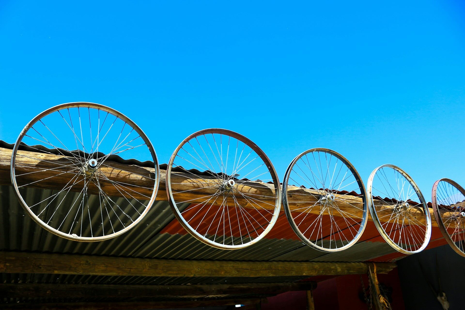 Bicycle wheels sitting on top of a roof